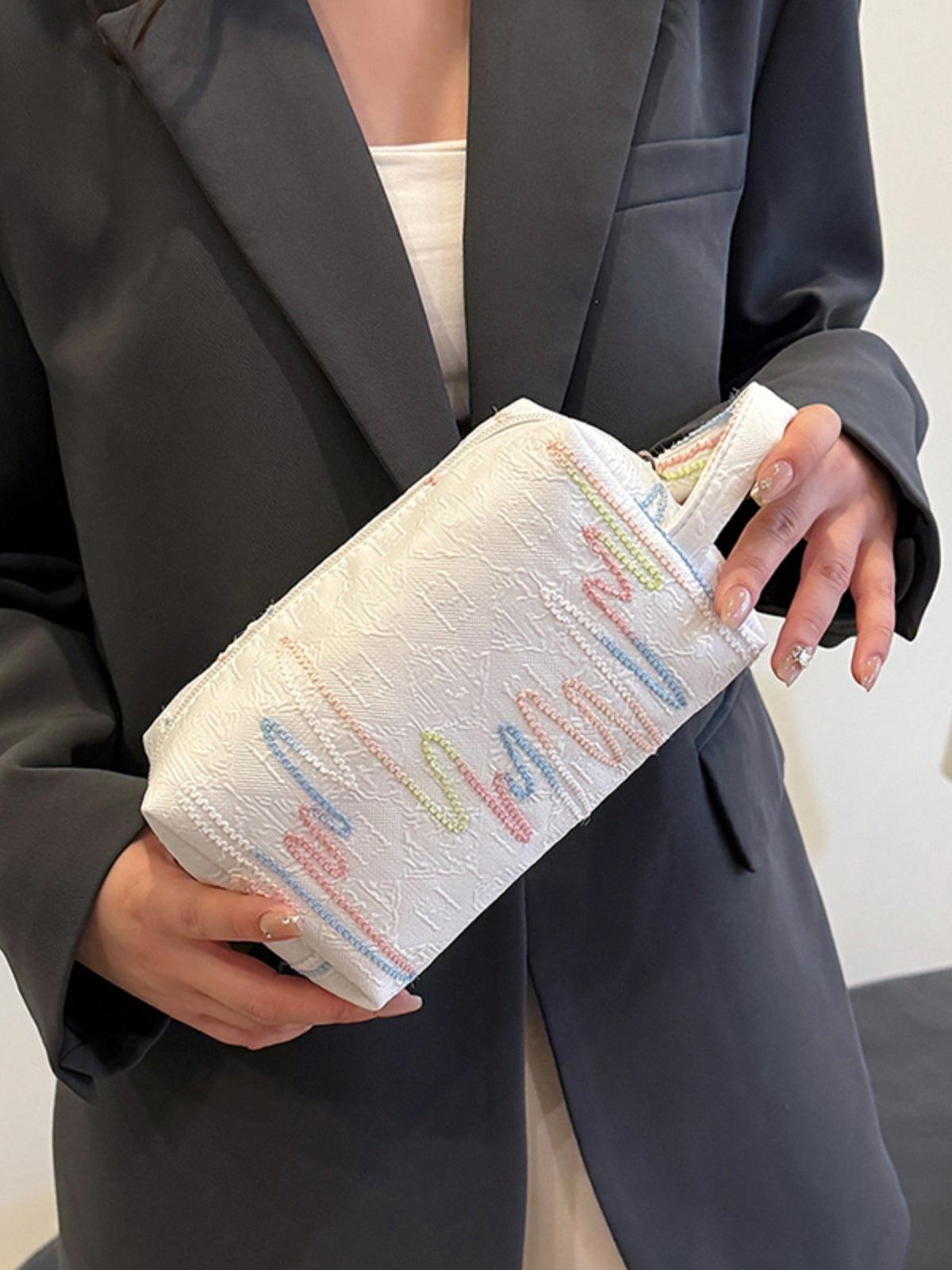 Pochette-bracelet en polyester contrastée avec fermeture éclair