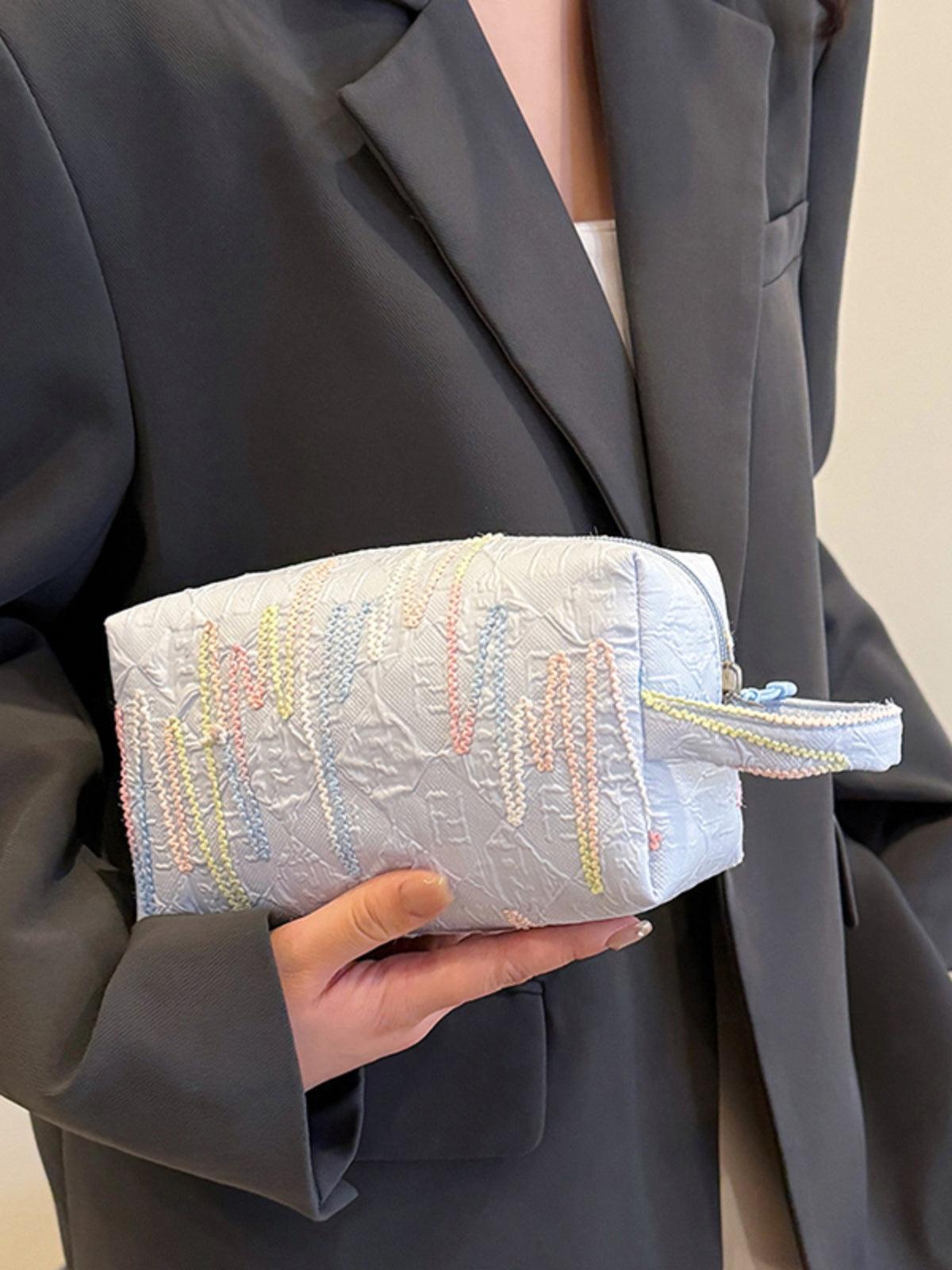 Pochette-bracelet en polyester contrastée avec fermeture éclair