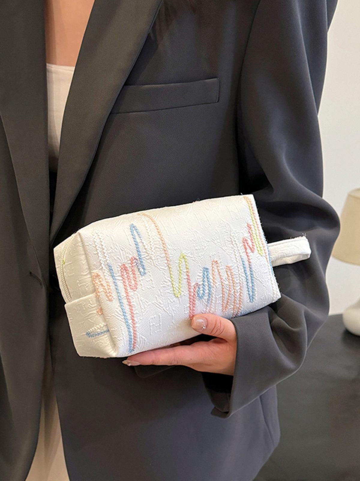 Pochette-bracelet en polyester contrastée avec fermeture éclair